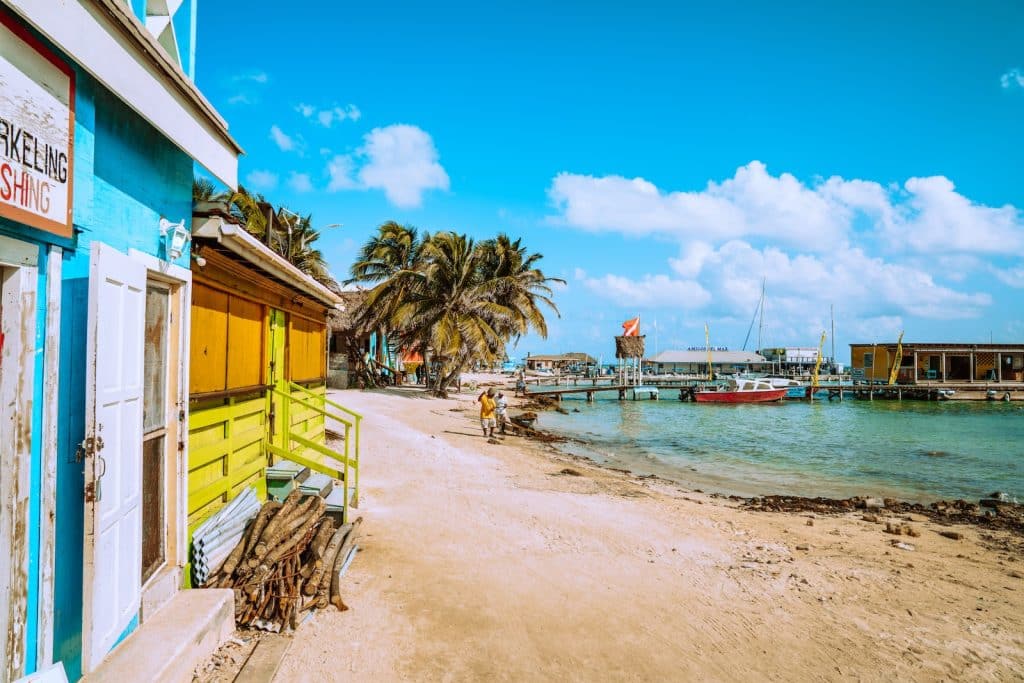 brown wooden beach chairs near body of water during daytime